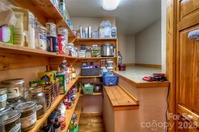 a view of a balcony with wooden floor and outdoor seating