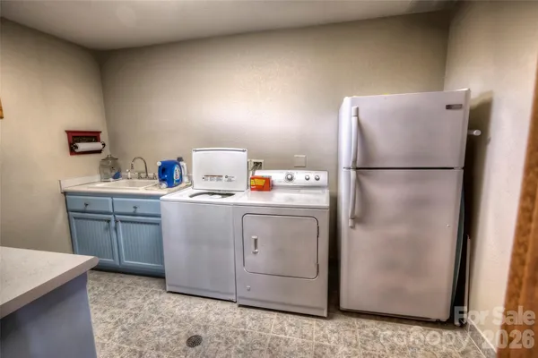 a utility room with cabinets washer and dryer