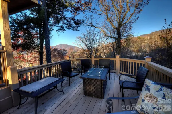 a view of a balcony with wooden floor and outdoor seating