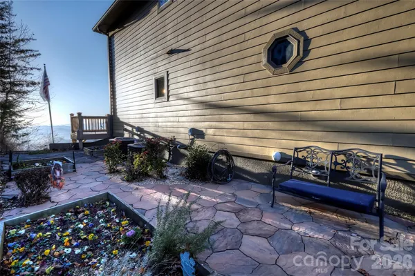 a view of a chairs and fire pit in the backyard