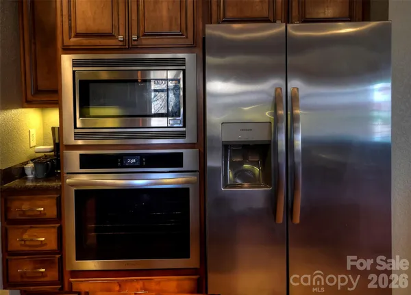 a kitchen with granite countertop cabinets and steel stainless steel appliances