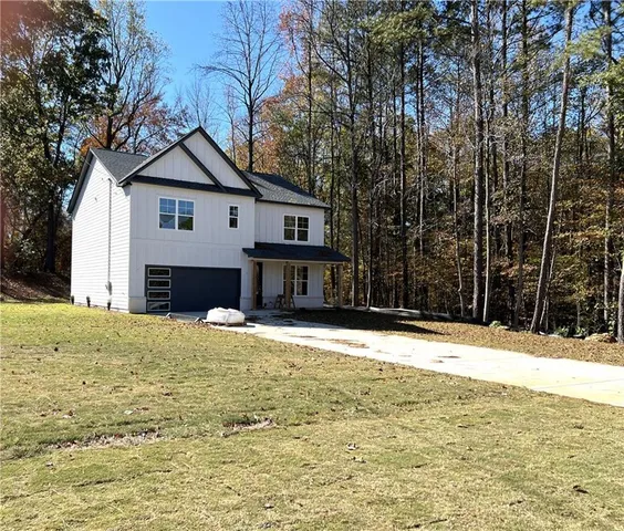 a house that has a tree in front of it