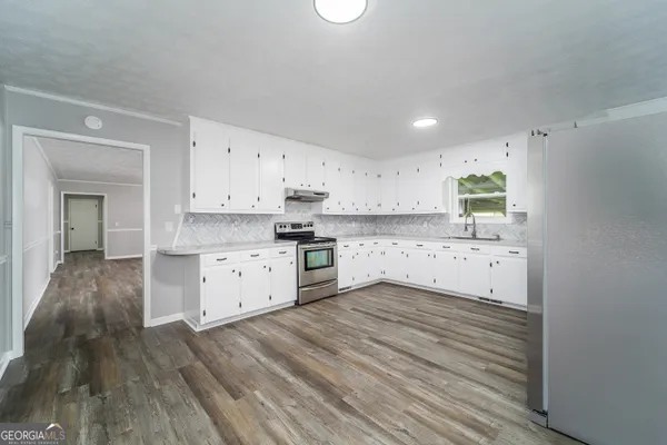 a view of kitchen with wooden floor