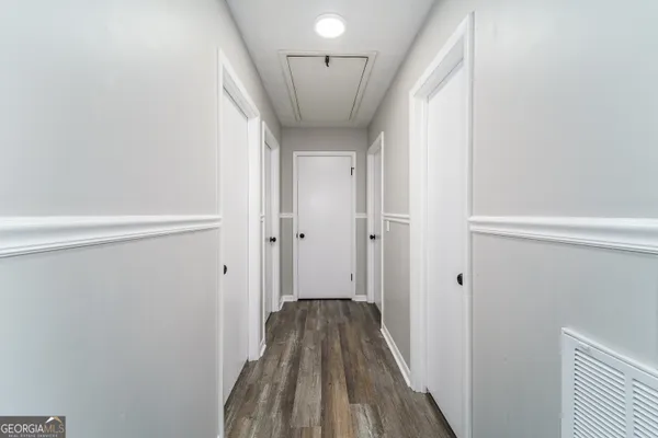 a view of hallway with wooden floor