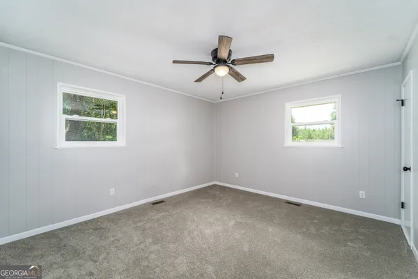 a view of room with window and ceiling fan