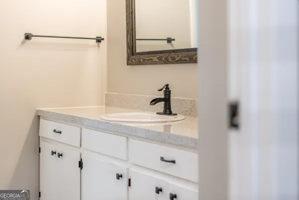 a bathroom with a sink and mirror