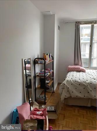 a view of a room with furniture and wooden floor