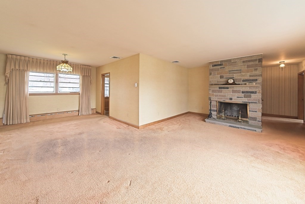 274 Kaufman Road Somerset, MA 02726 - Photo 5 of 13 en empty room with windows and fireplace