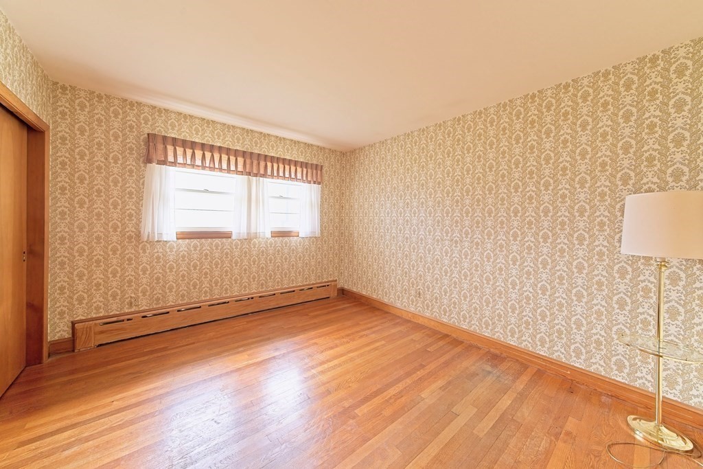 274 Kaufman Road Somerset, MA 02726 - Photo 9 of 13 a view of an empty room with wooden floor and a window