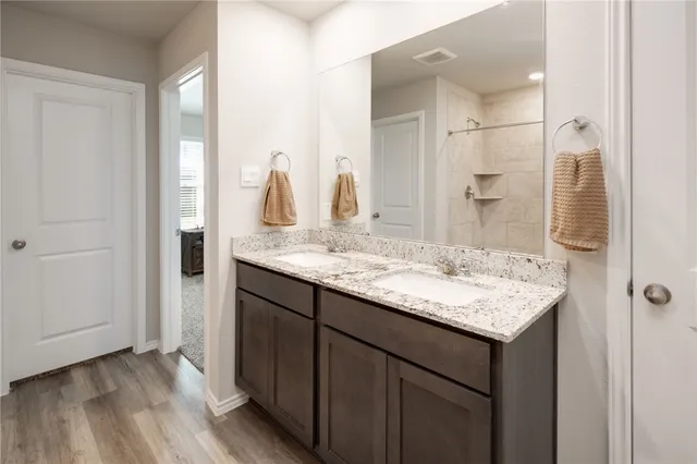 a view of walk in closet with clothes