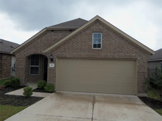 a front view of a house with yard
