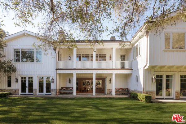 front view of a brick building with a yard