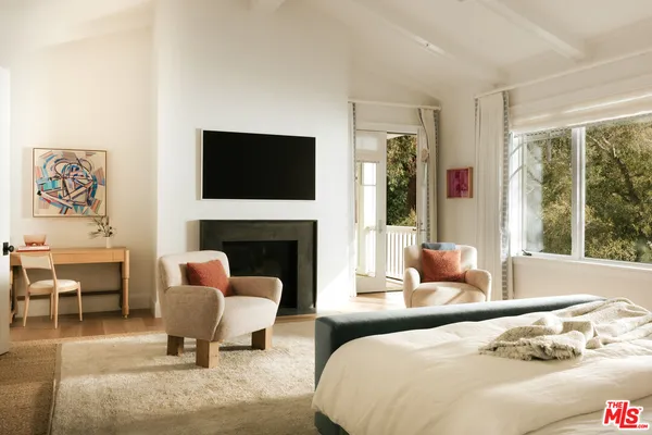 a bedroom with a bed and a fireplace