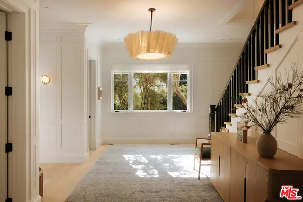 a view of an entryway with wooden floor