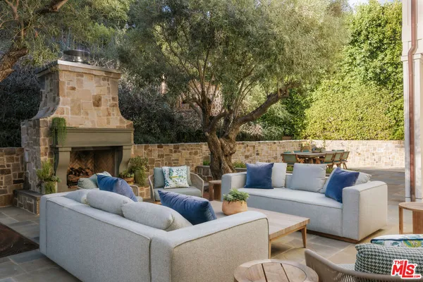 a outdoor living space with furniture and a fireplace