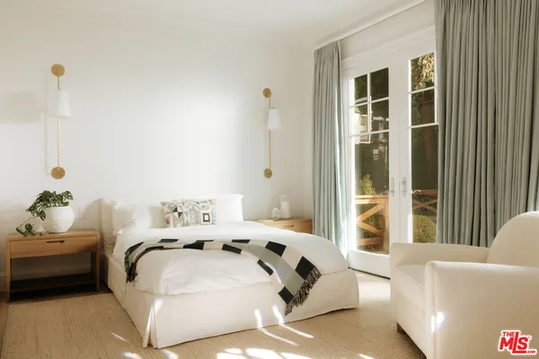 a bedroom with furniture and a window