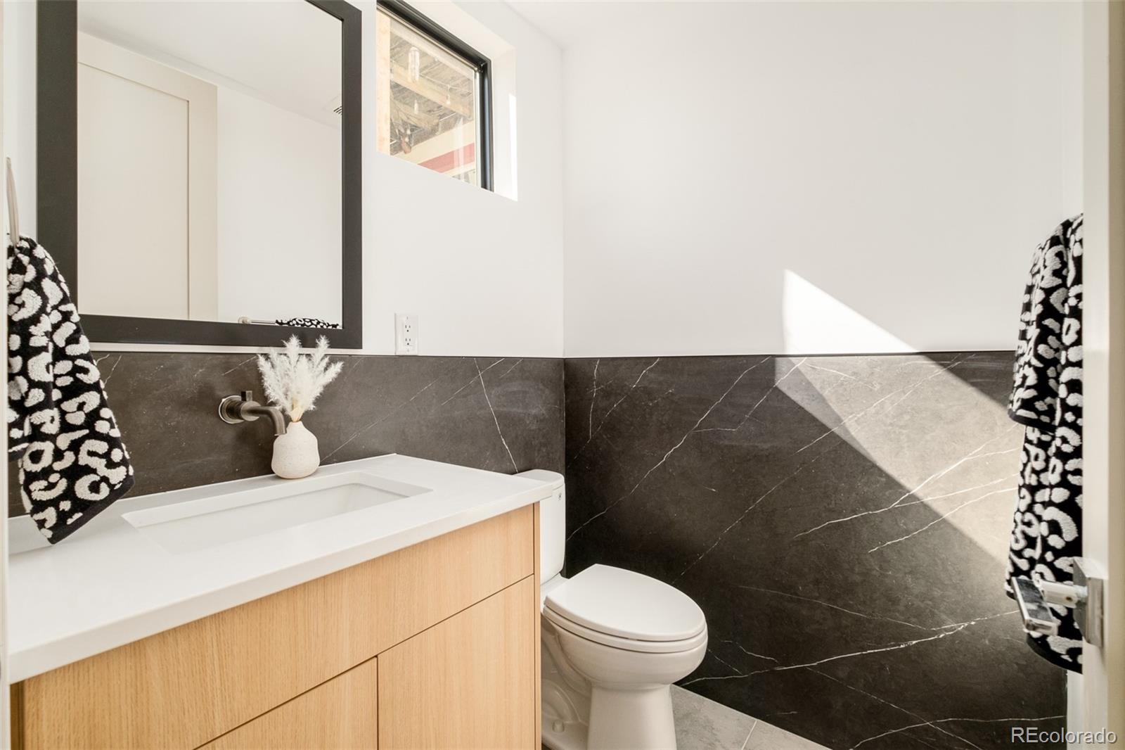 3554 Osage Street Denver, CO 80211 - Photo 13 of 40 a bathroom with a sink and a toilet