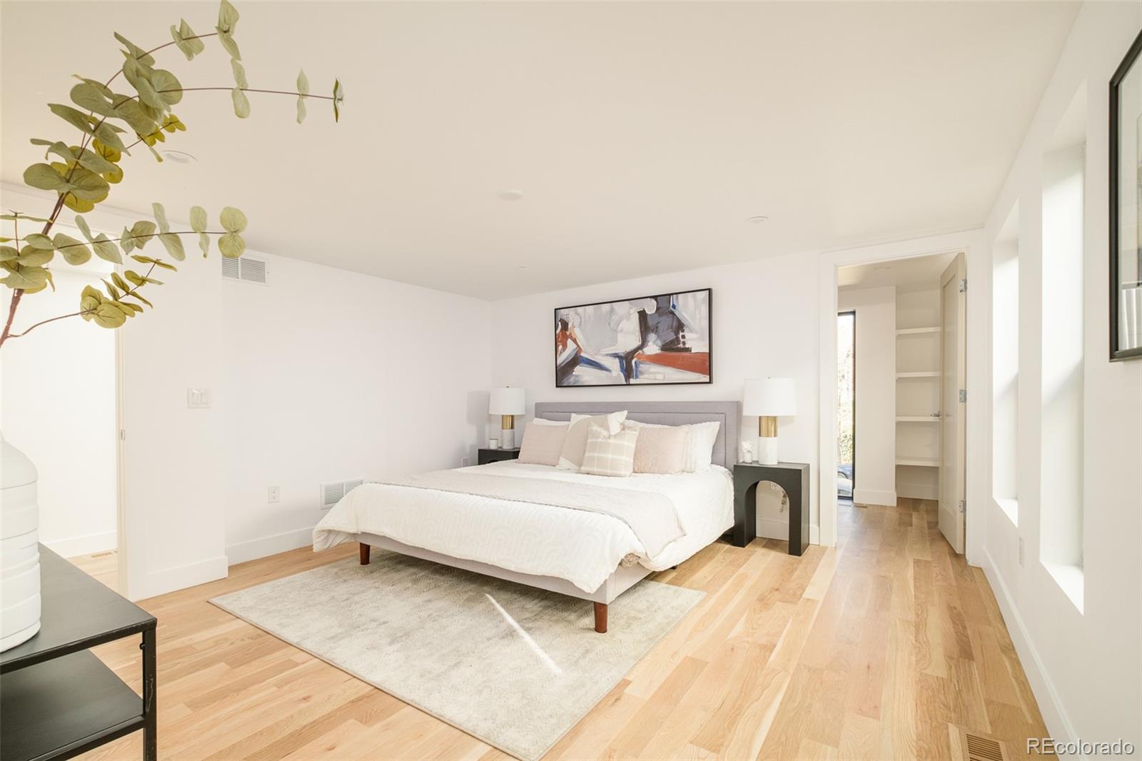 3554 Osage Street Denver, CO 80211 - Photo 18 of 40 a bedroom with a bed and a painting on the wall