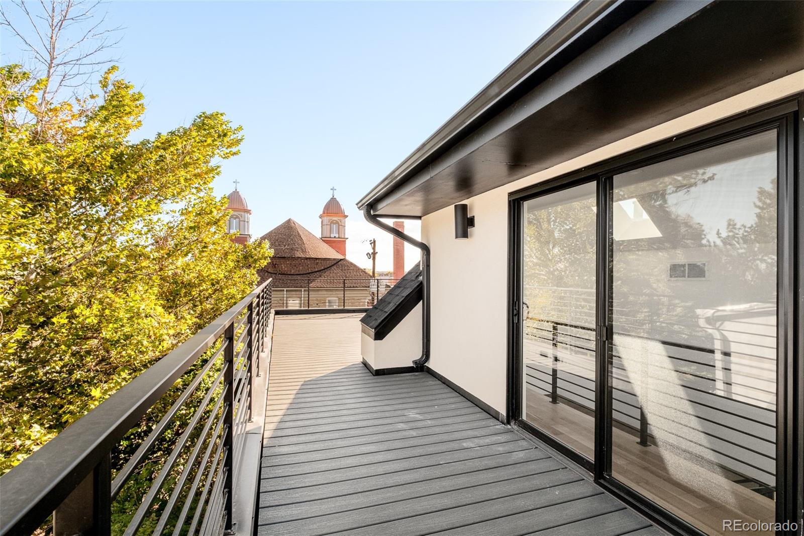 3554 Osage Street Denver, CO 80211 - Photo 33 of 40 a view of a balcony with wooden floor and iron stairs