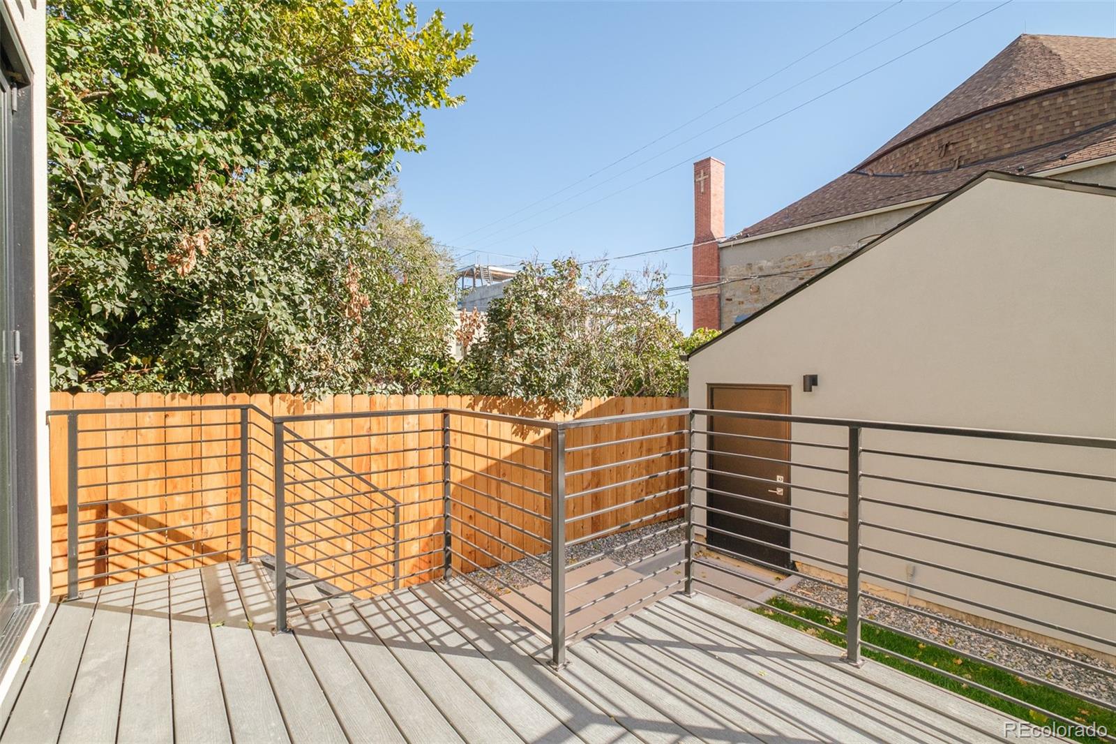 3554 Osage Street Denver, CO 80211 - Photo 40 of 40 a view of a balcony with wooden floor and fence