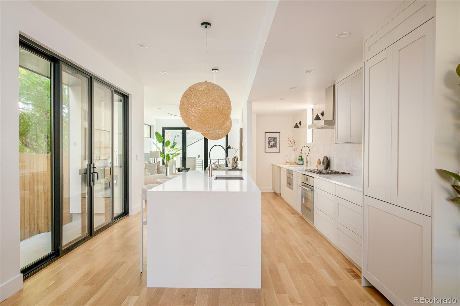 3554 Osage Street Denver, CO 80211 - Photo 6 of 40 a large kitchen with lot of counter space and wooden floor
