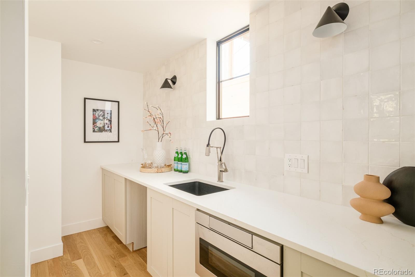 3554 Osage Street Denver, CO 80211 - Photo 9 of 40 a kitchen with a sink and a window