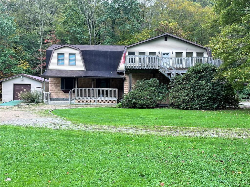 345 Duck Hollow Road Uniontown, PA 15401 - Photo 25 of 25 a front view of a house with a garden and trees