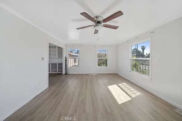 wooden floor in an empty room with a window