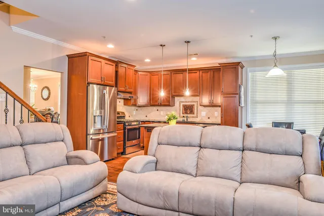 a living room with furniture a ceiling fan and a window