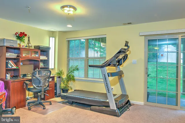 a view of a house with a backyard balcony and a garden