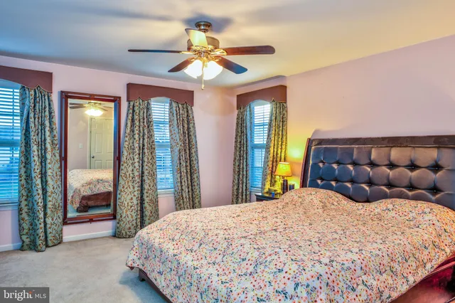 a bathroom with a granite countertop toilet sink and mirror