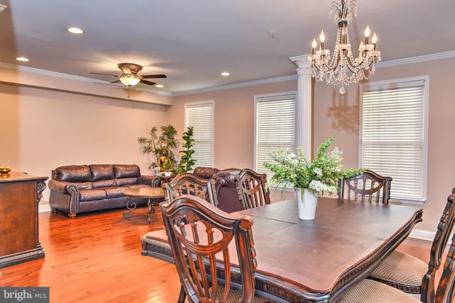 a dining room filled with furniture and chandelier