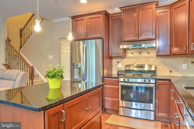 a kitchen with a stove a sink and a refrigerator