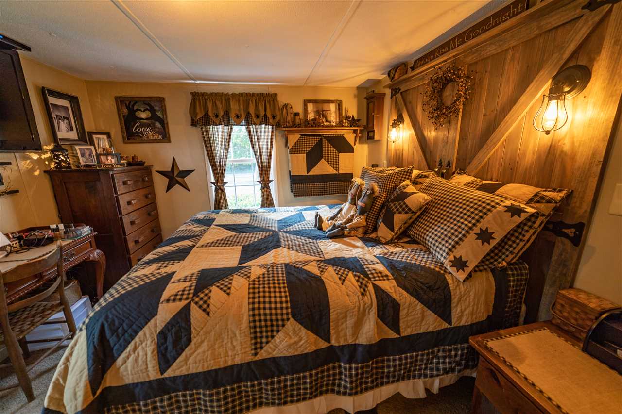 1365 George Walton Road Mount Solon, VA 22843 - Photo 14 of 28 a bed sitting in a bedroom next to a window