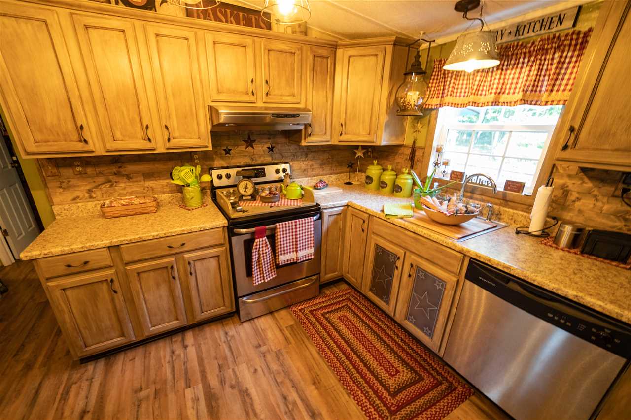 1365 George Walton Road Mount Solon, VA 22843 - Photo 8 of 28 a kitchen with stainless steel appliances granite countertop a sink a stove refrigerator and cabinets