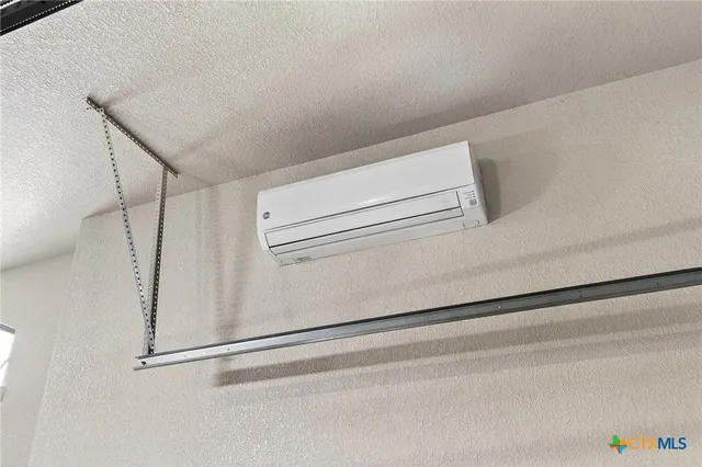 an empty room with wooden floor and window