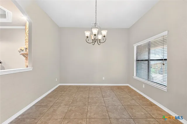 a view of a hallway with furniture and a window