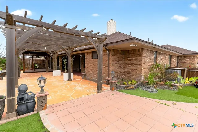 a view of a house with yard and sitting area
