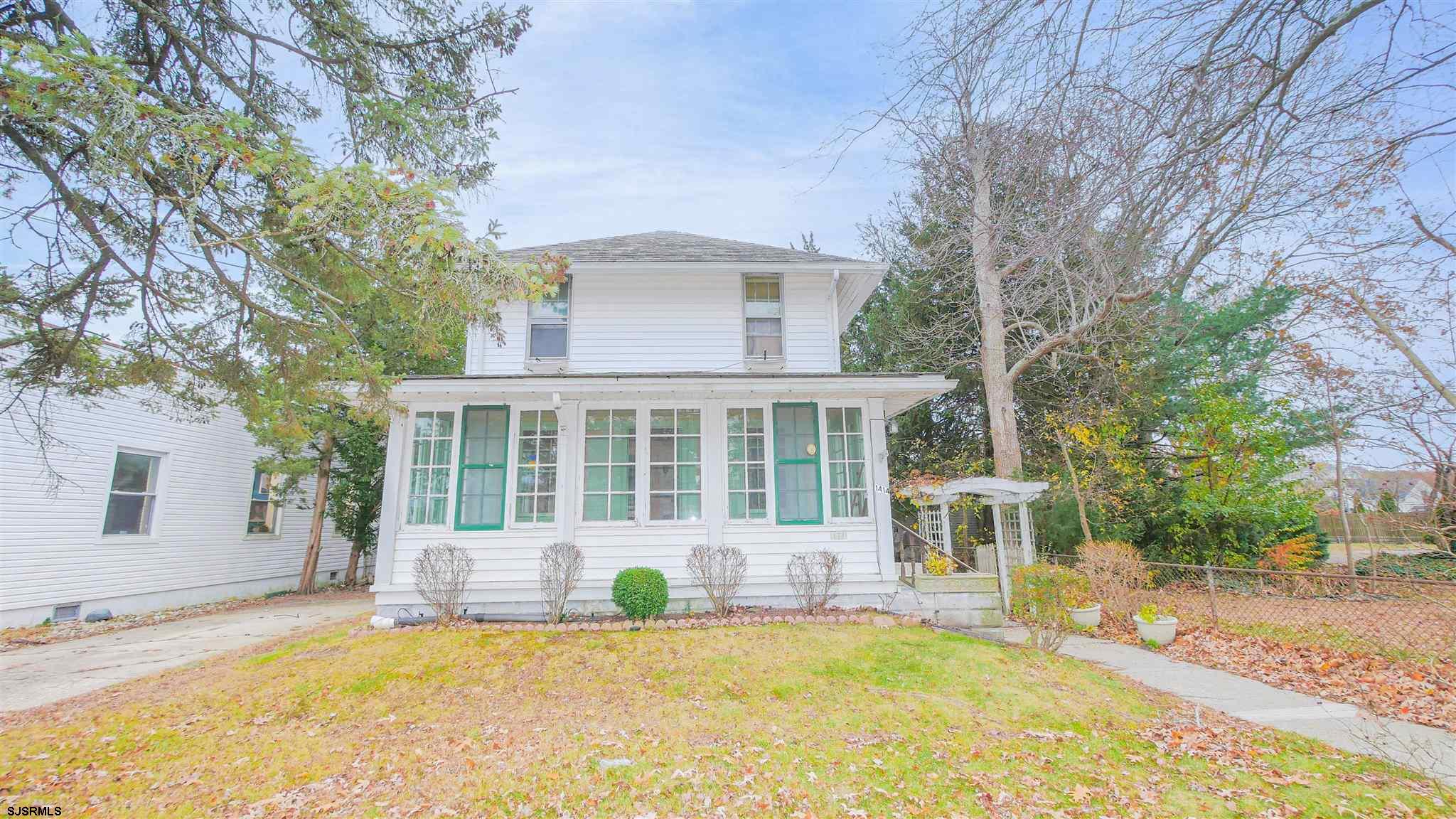 1414 Shore Road Northfield, NJ 08225 - Photo 1 of 19 a front view of a house with a yard and trees