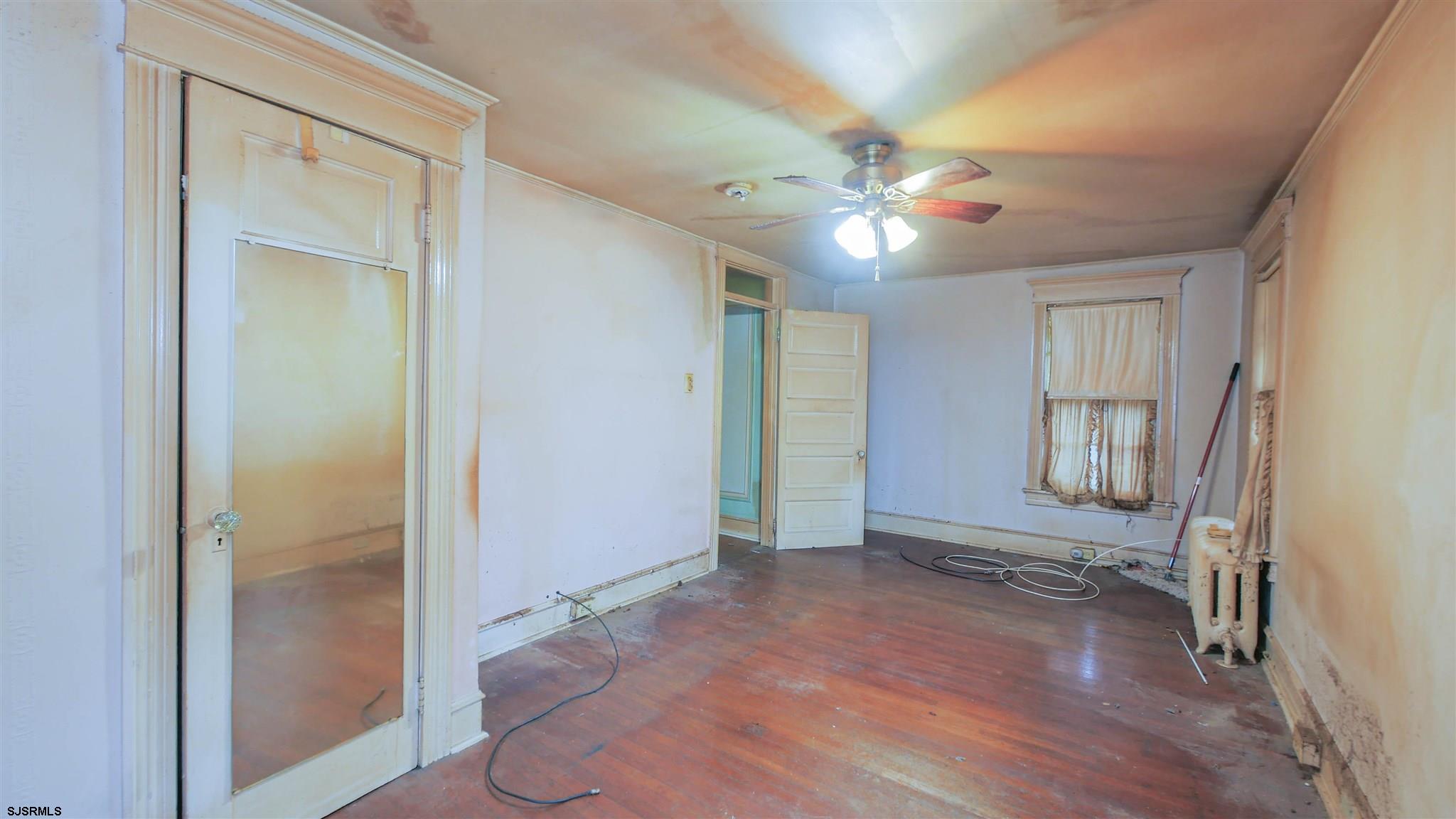 1414 Shore Road Northfield, NJ 08225 - Photo 11 of 19 wooden floor in an empty room with a window