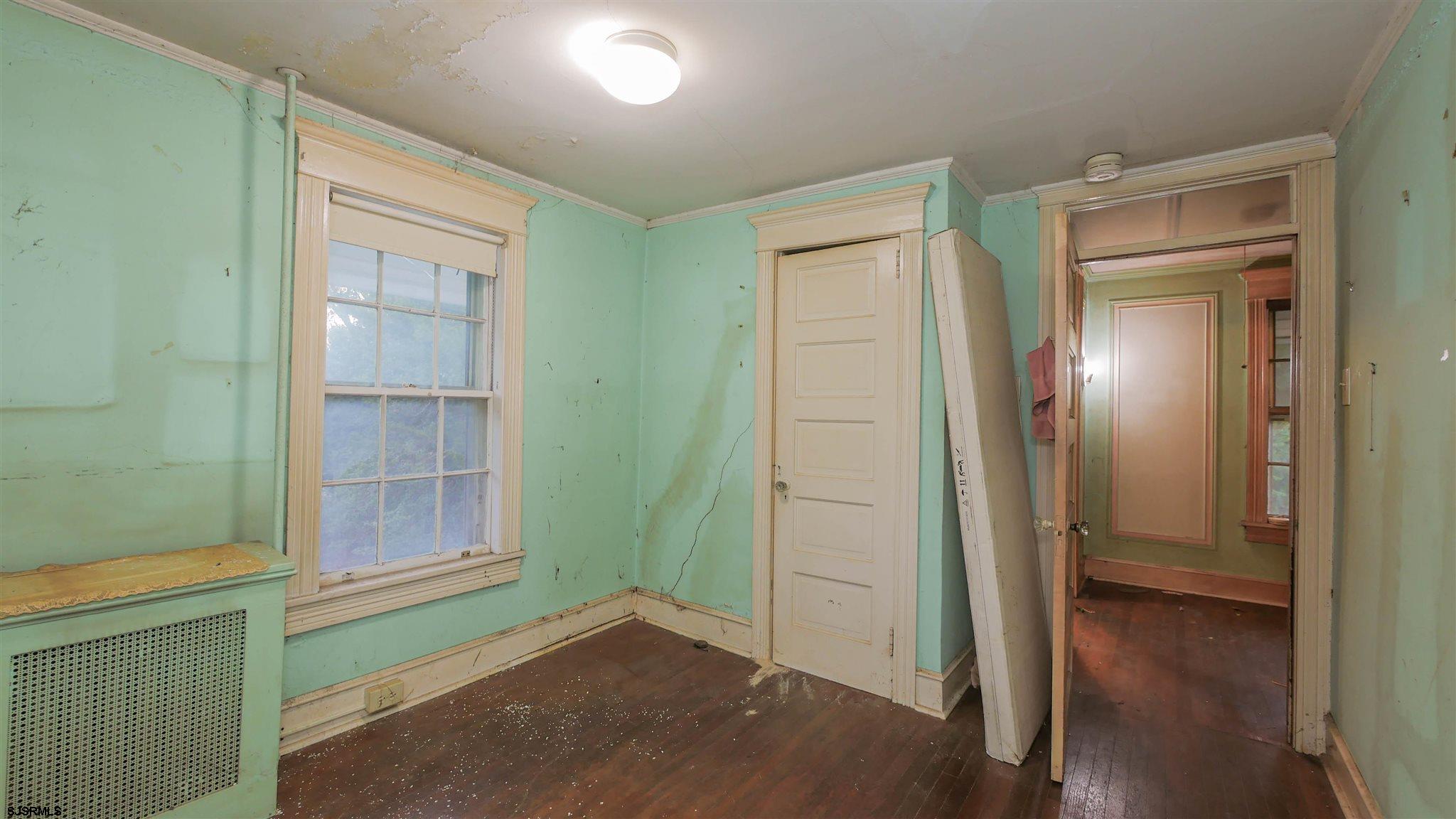 1414 Shore Road Northfield, NJ 08225 - Photo 14 of 19 an empty room with wooden floor closet and windows