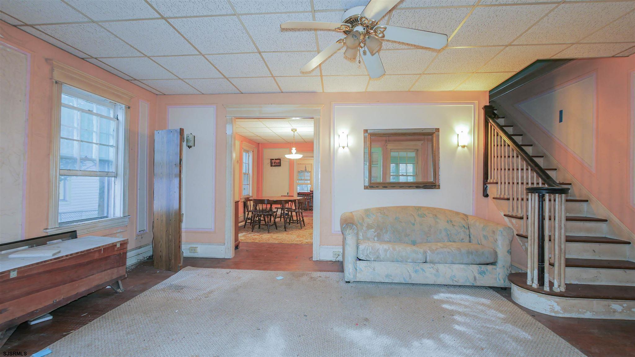 1414 Shore Road Northfield, NJ 08225 - Photo 4 of 19 a living room with furniture and a chandelier