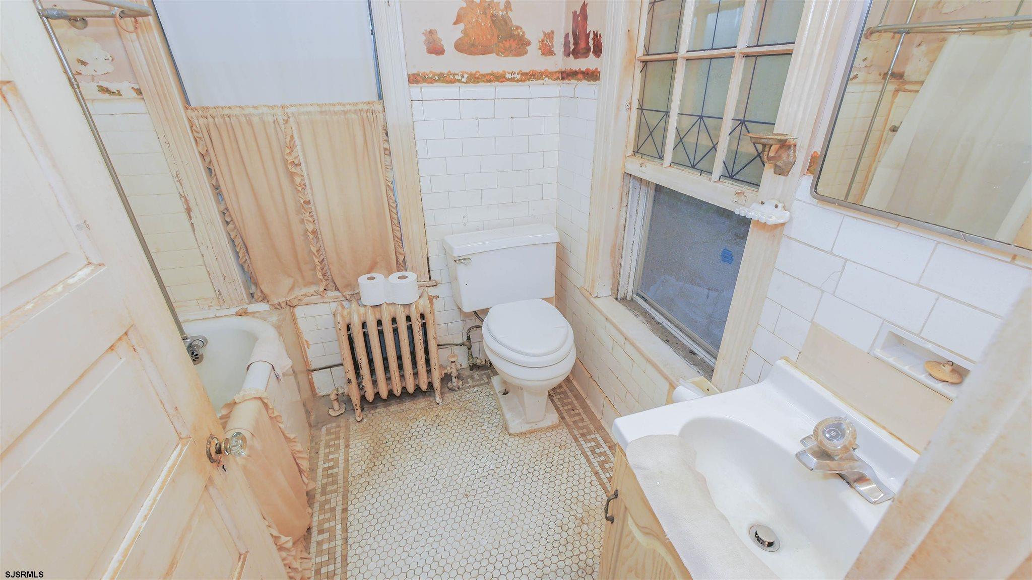 1414 Shore Road Northfield, NJ 08225 - Photo 10 of 19 a bathroom with a sink toilet and shower