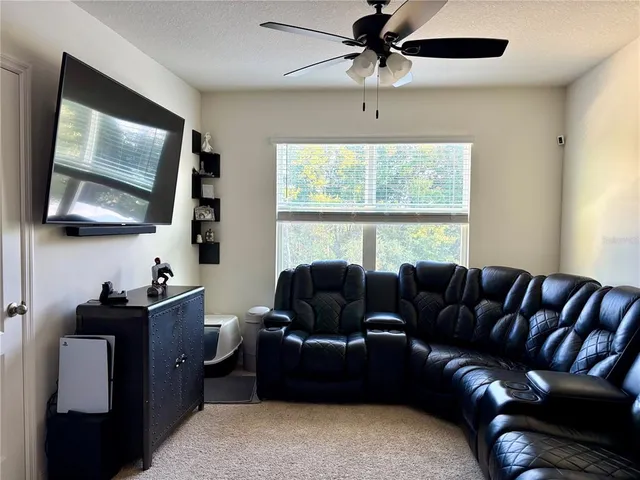 a spacious bedroom with a bed dresser and a window