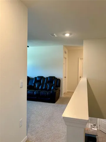 a bedroom with a bed and a flat tv screen on dresser