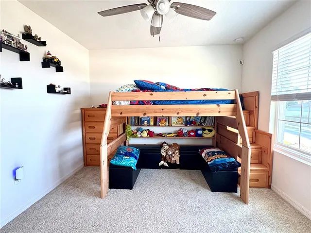 a spacious bedroom with a bed and a window
