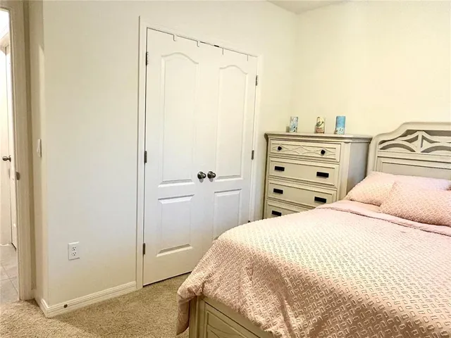 a bathroom with a granite countertop sink a toilet and a mirror