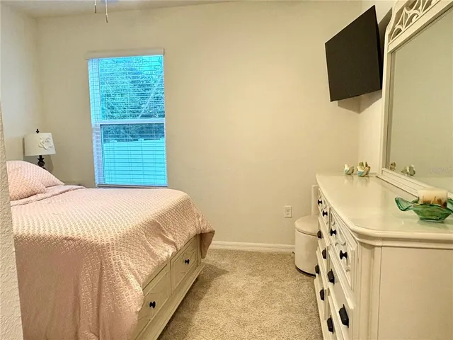 a bathroom with a granite countertop sink a mirror and a bathtub