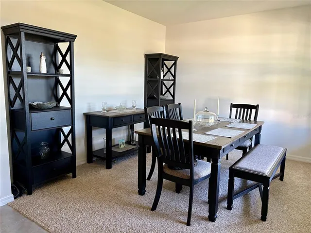 a large kitchen with stainless steel appliances granite countertop a sink counter space cabinets and a large window