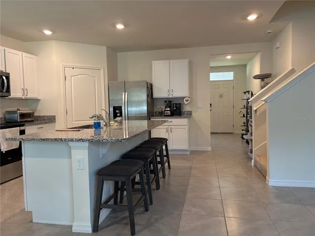 a bathroom with a bathtub and cabinets